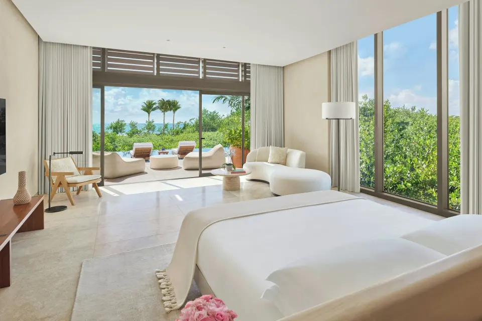 Ocean-view guest room with a king bed at The Riviera Maya EDITION At Kanai.