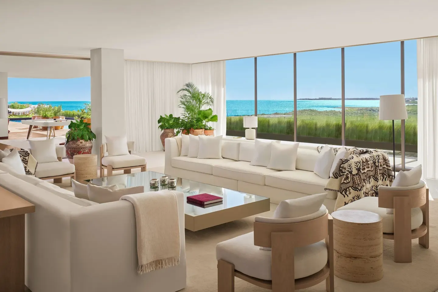Ocean-view living room with white sofas at The Riviera Maya EDITION At Kanai.