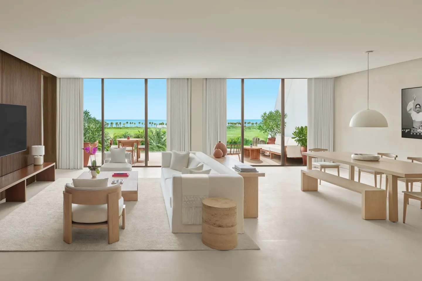 Ocean-view living and dining area in a suite at The Riviera Maya EDITION At Kanai.
