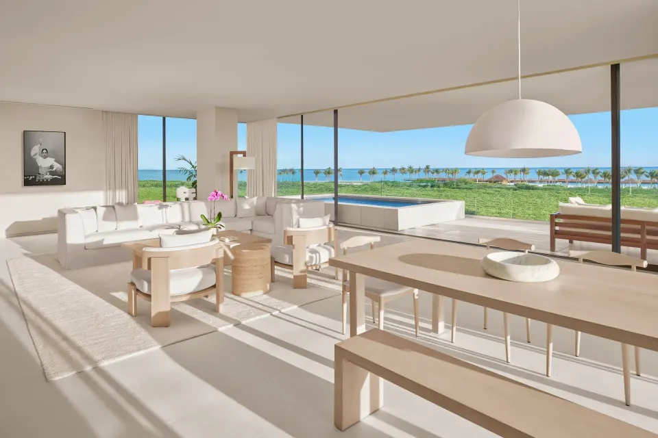 Ocean-view suite living room at The Riviera Maya EDITION At Kanai with dining table and terrace pool.