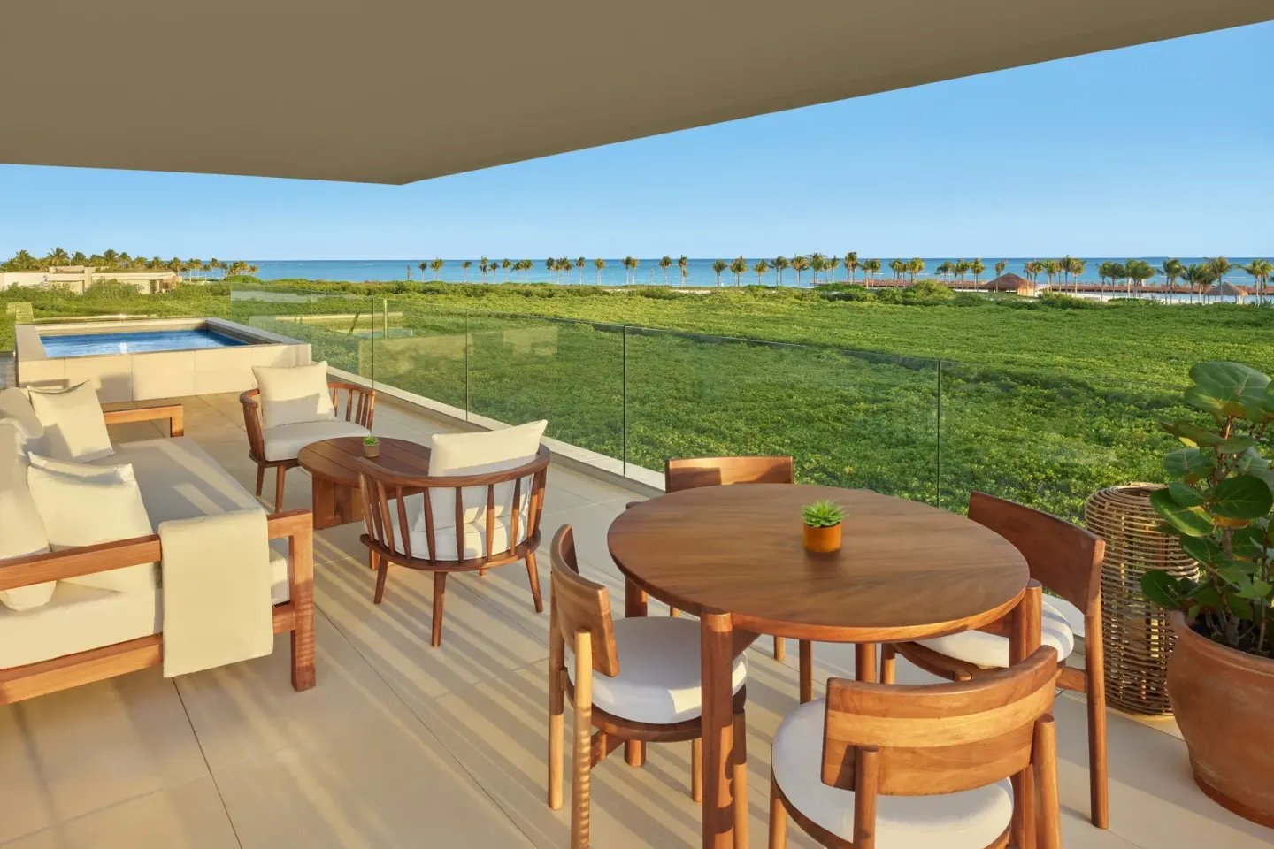 Ocean-view terrace with dining table and plunge pool at The Riviera Maya EDITION At Kanai.
