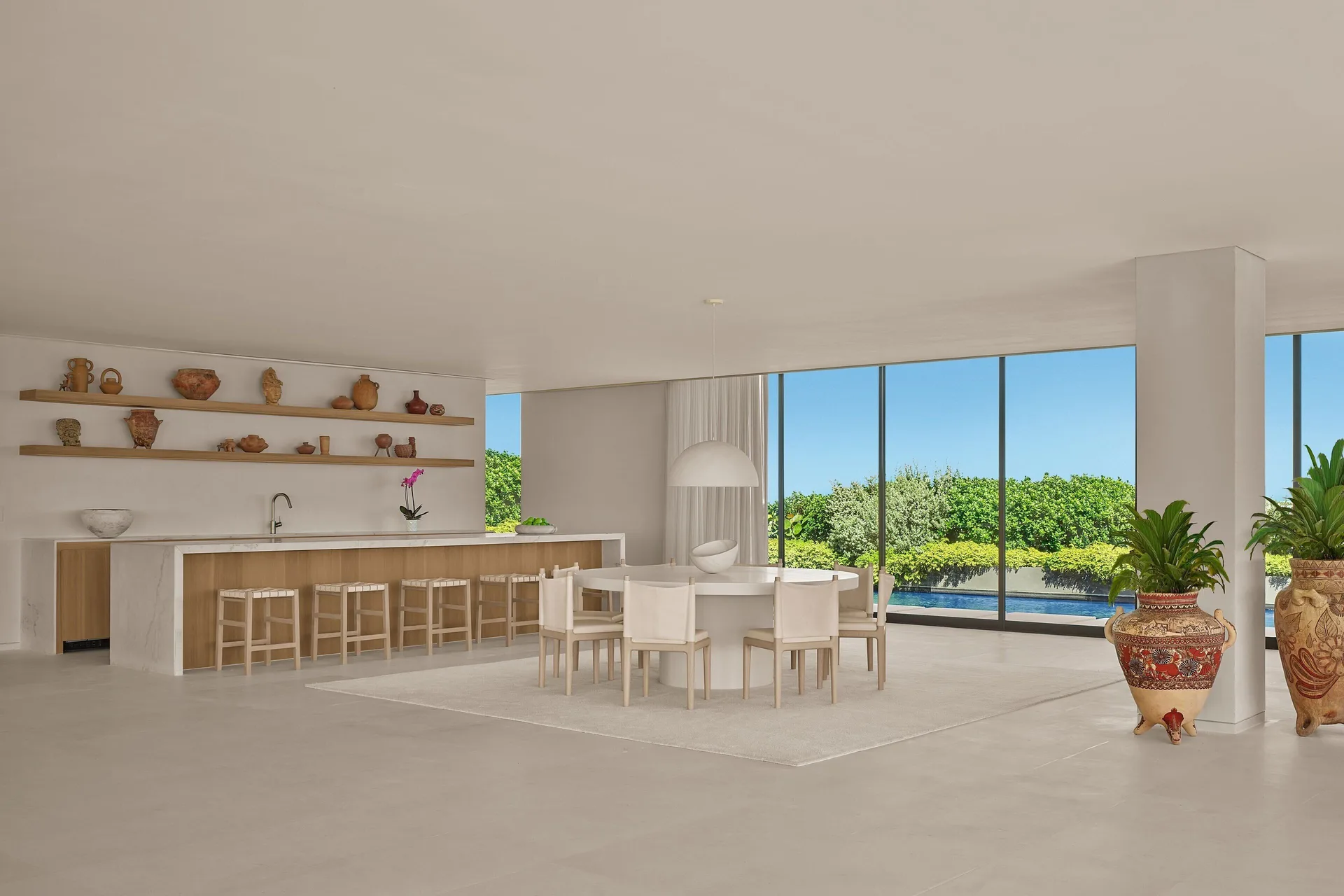 Open dining and lounge area with greenery views at The Riviera Maya EDITION At Kanai.