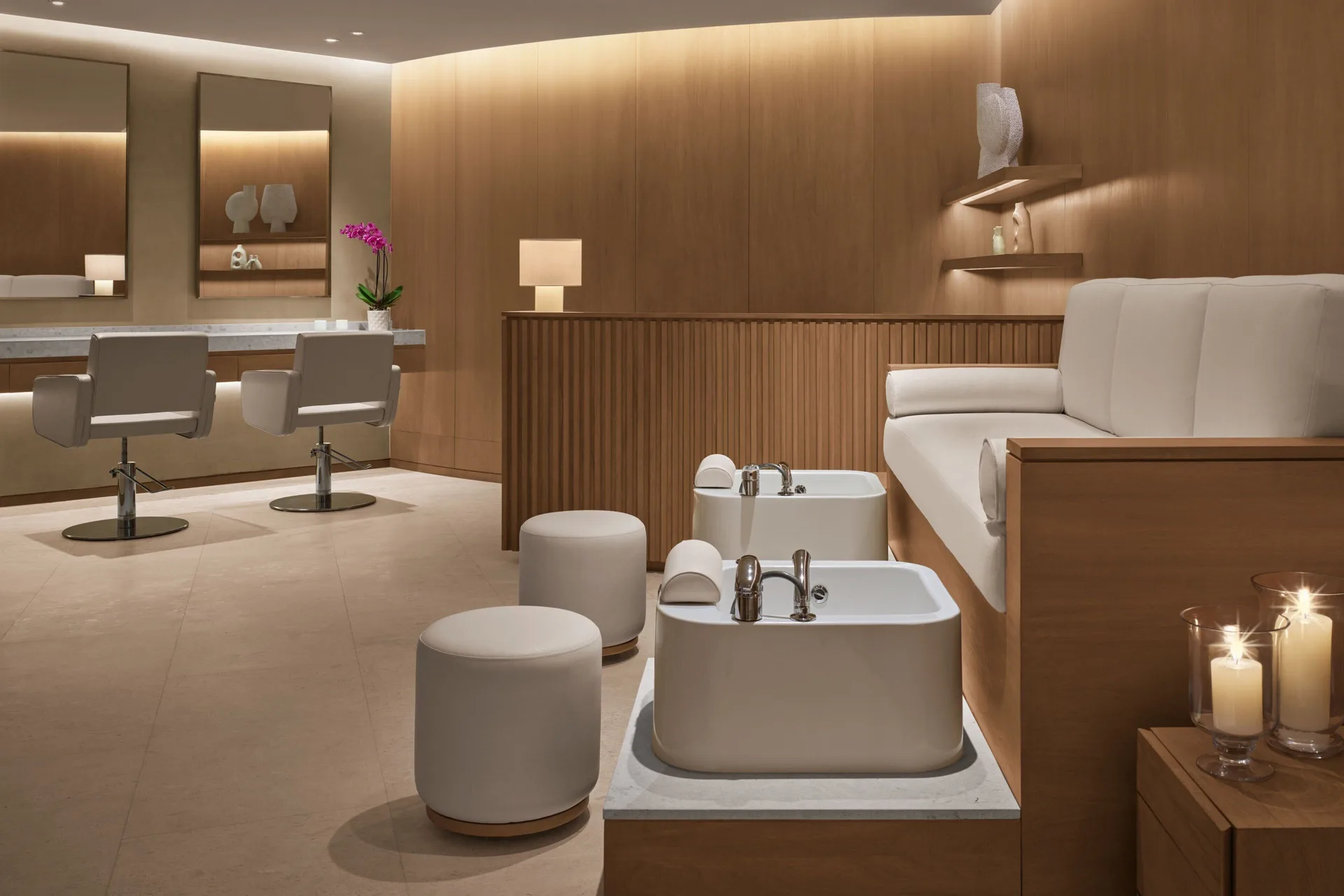 A spa pedicure area with lounge seating and mirrors at The Riviera Maya EDITION At Kanai.