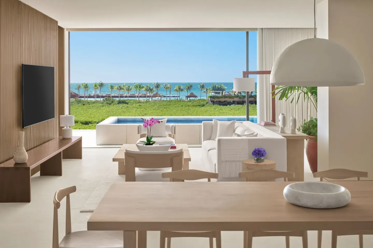 Suite living and dining area with ocean view at The Riviera Maya EDITION At Kanai.