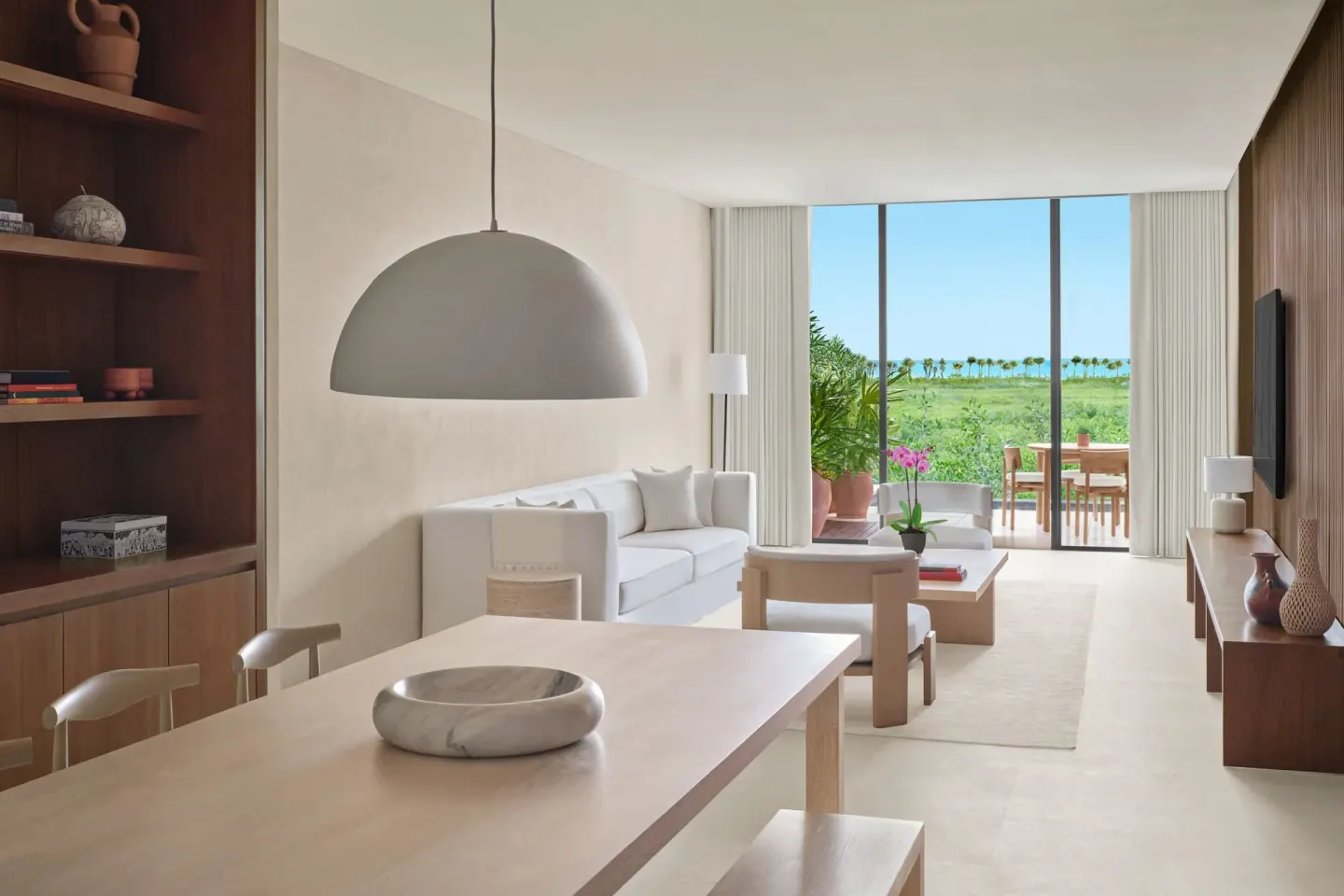 Suite living room with terrace and greenery at The Riviera Maya EDITION At Kanai.