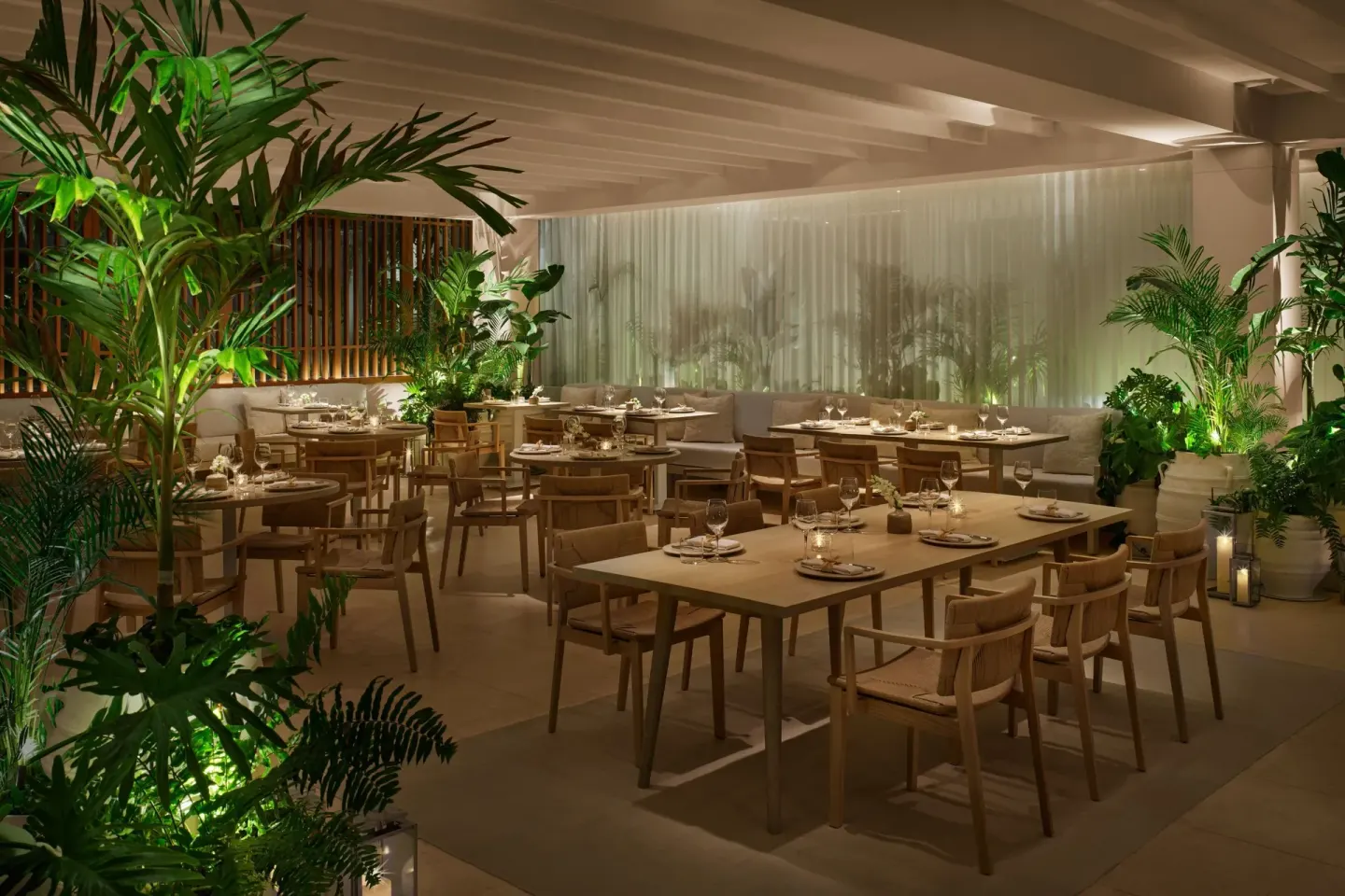 Indoor dining room with tropical plants at The Riviera Maya EDITION At Kanai.