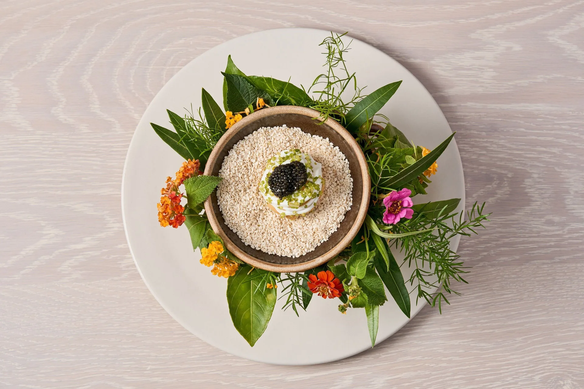 Plated seafood dish with caviar and flowers at The Riviera Maya EDITION At Kanai.