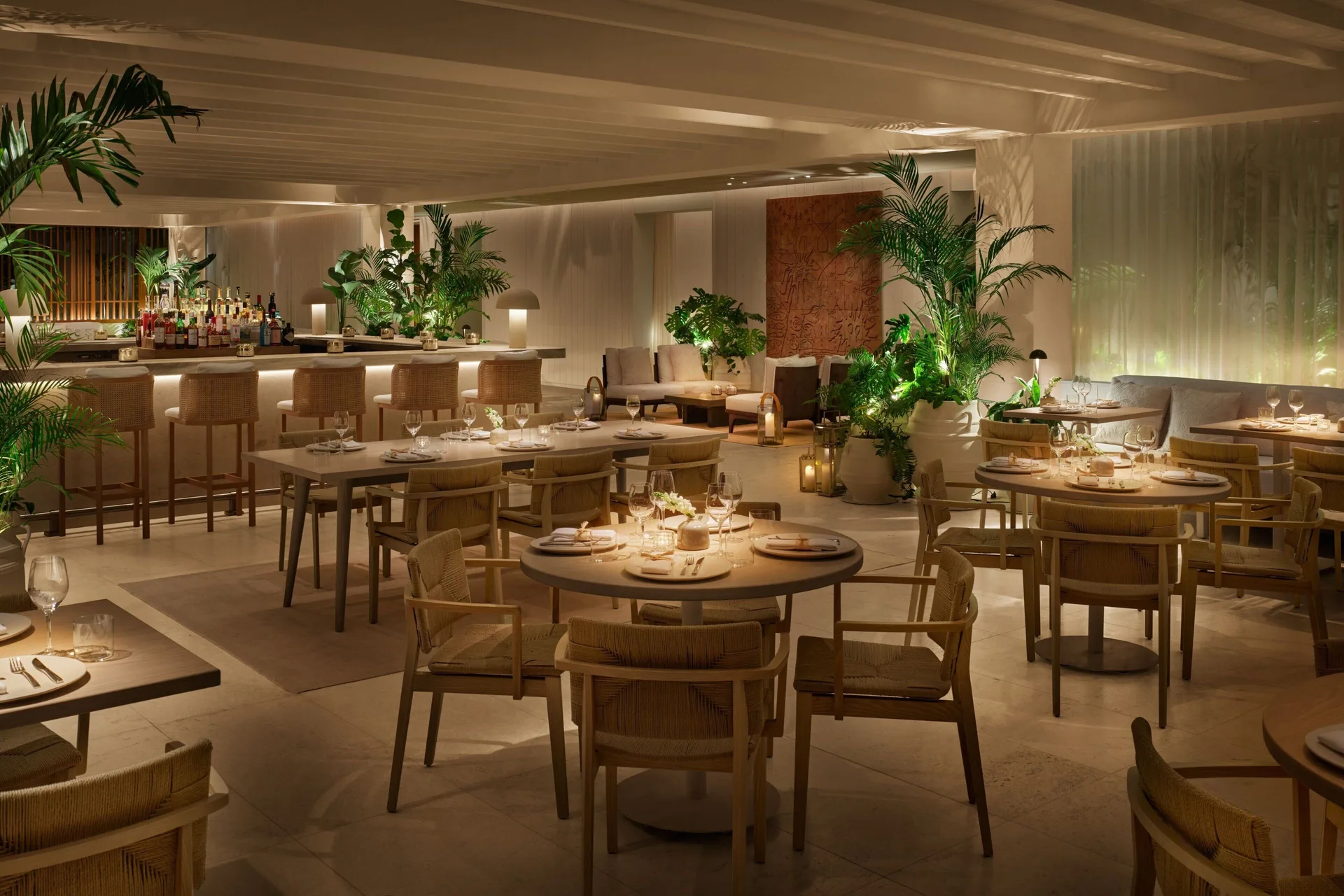 Warm restaurant dining room and bar at The Riviera Maya EDITION At Kanai.