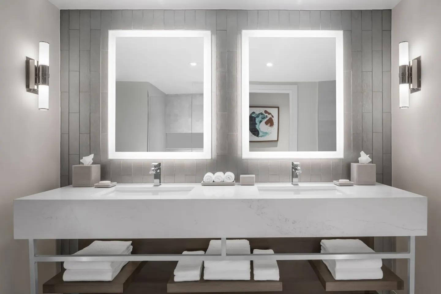 Double vanity with illuminated mirrors in a bathroom at The Royal at Atlantis.