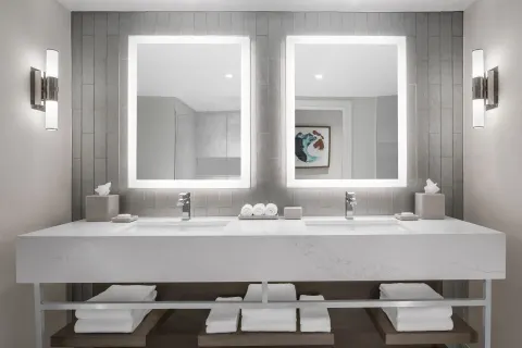 Double vanity with illuminated mirrors in a bathroom at The Royal at Atlantis.
