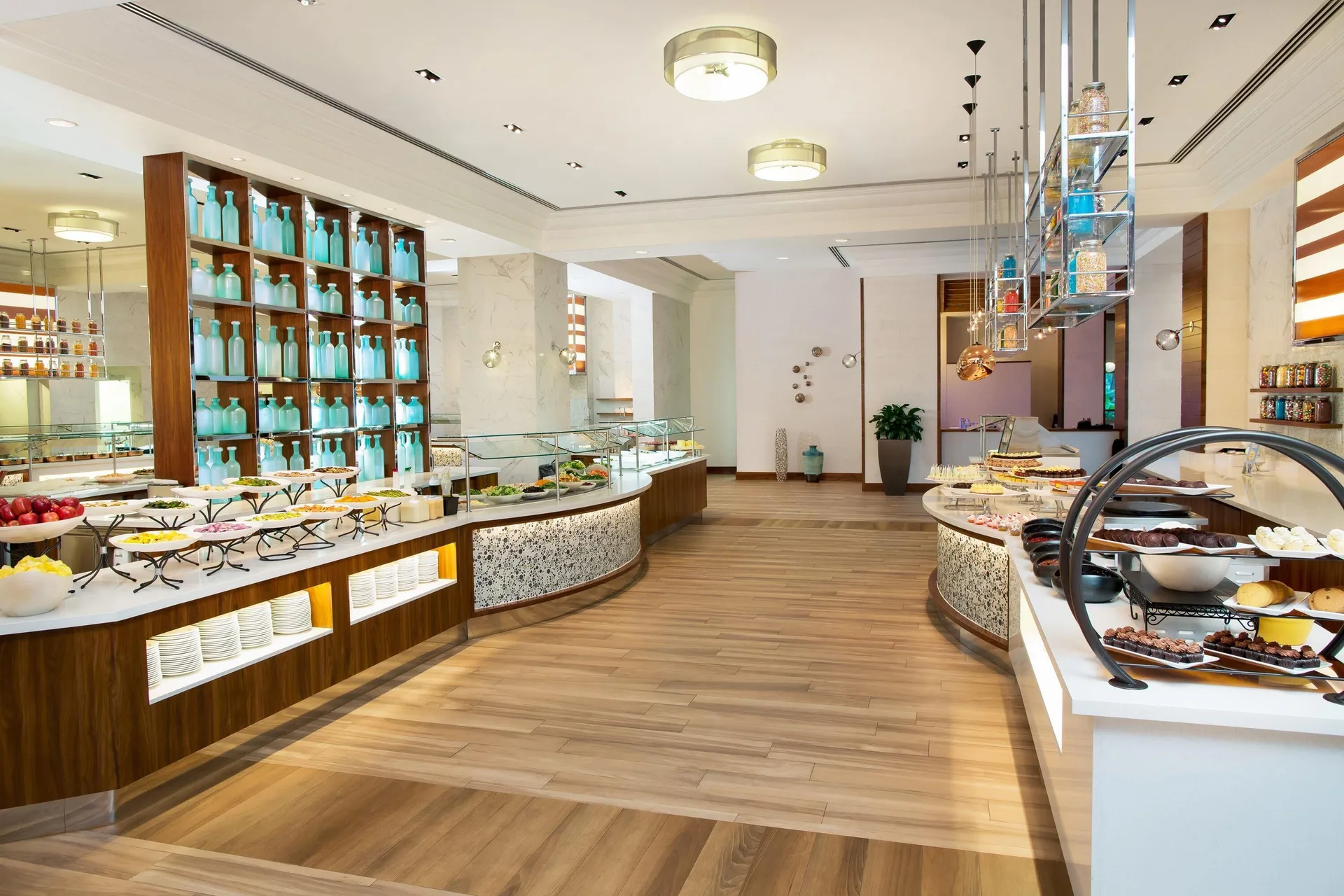A buffet dining room displays fruit, pastries, and serving stations at The Royal at Atlantis.