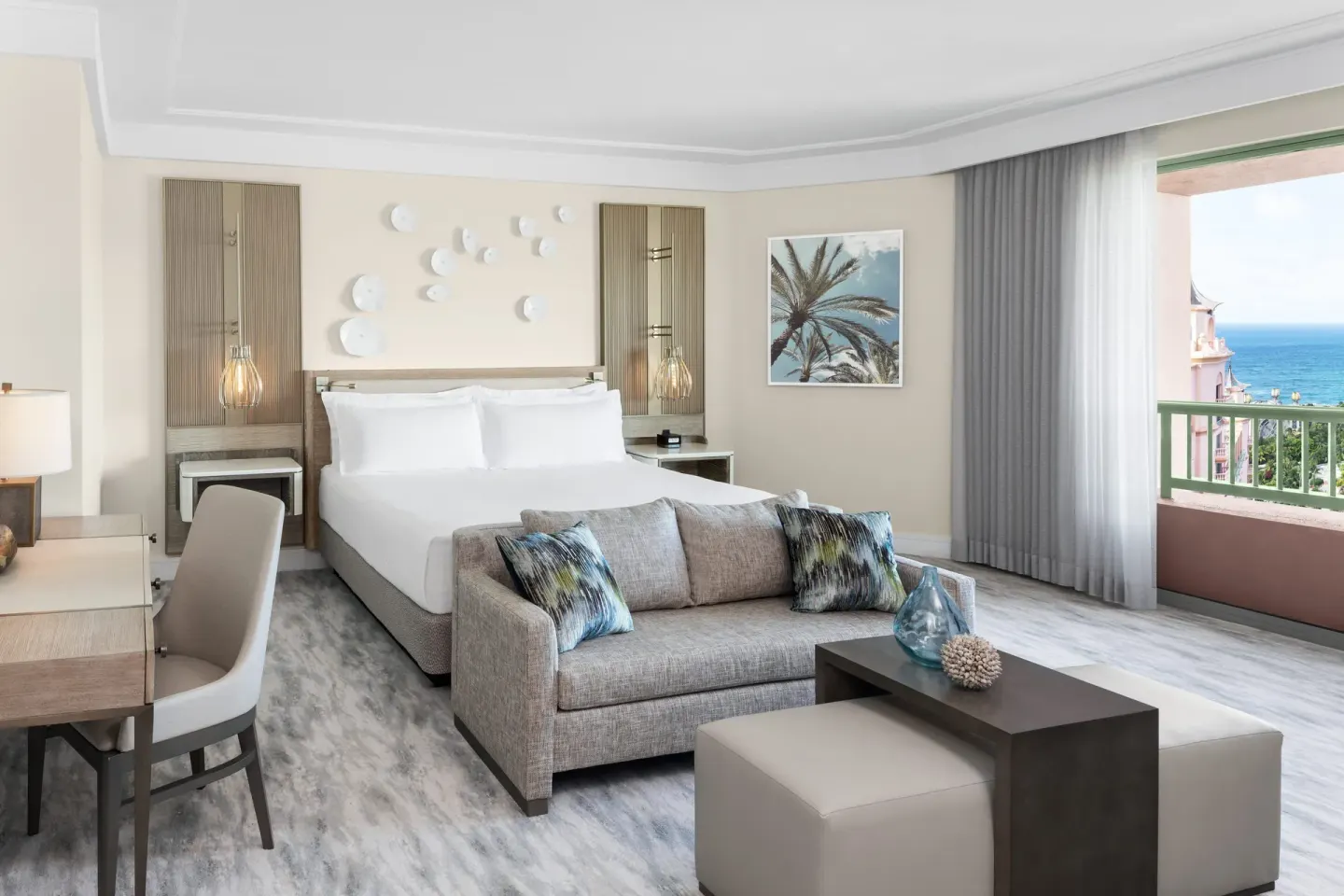 1 Bedroom Regal Suite bedroom with king bed and ocean-view balcony at The Royal at Atlantis.