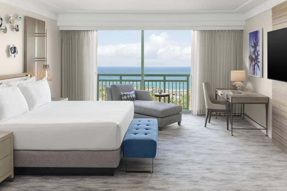 Imperial Club suite bedroom with king bed and ocean-facing balcony at The Royal at Atlantis.