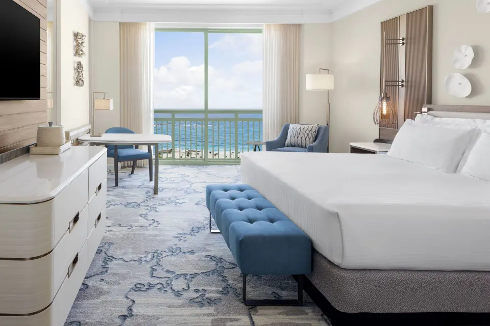 King-bed Water View guest room with balcony and ocean beyond at The Royal at Atlantis.