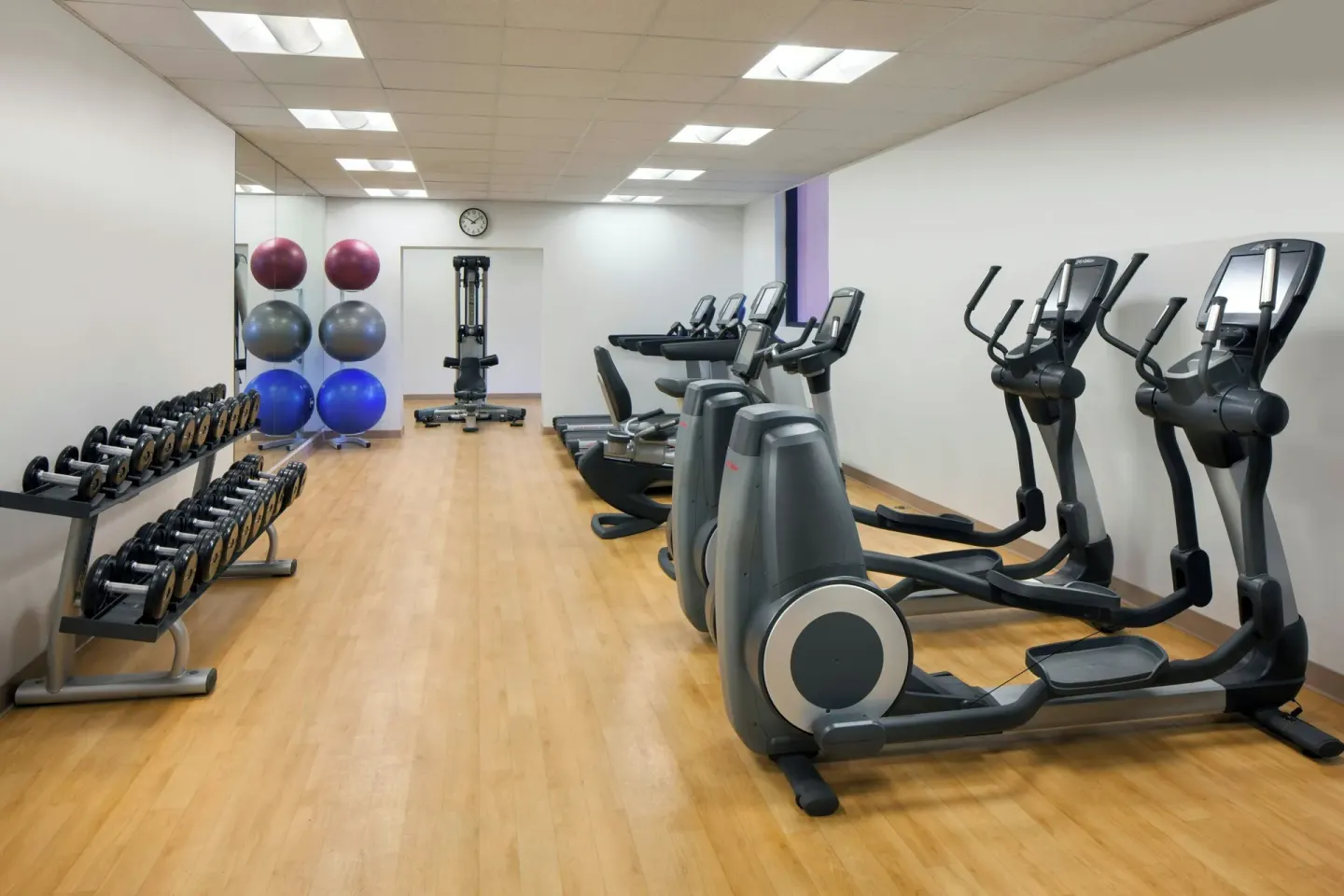 Fitness center with ellipticals, treadmills, dumbbells, and exercise balls at The Royal Hawaiian, Waikiki.