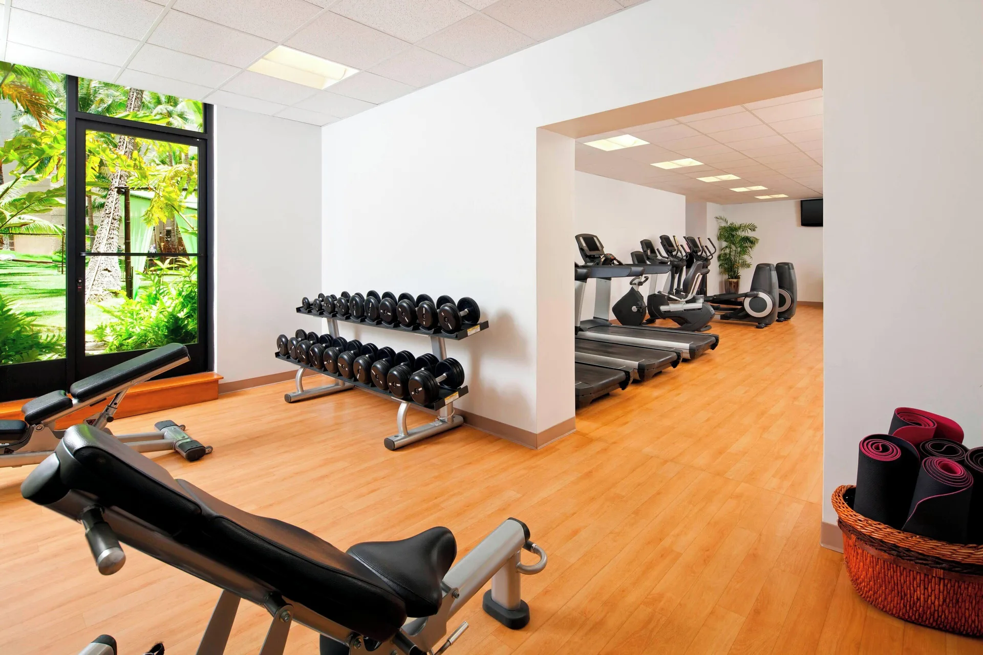 Fitness room with weights, treadmills, and garden windows at The Royal Hawaiian, Waikiki.