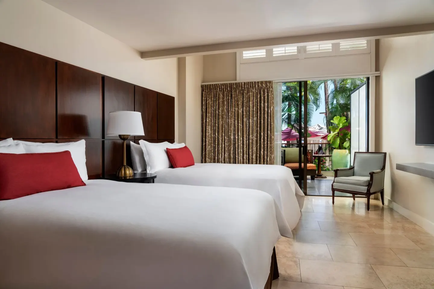 Two beds in a guest room with a lanai at The Royal Hawaiian, Waikiki.