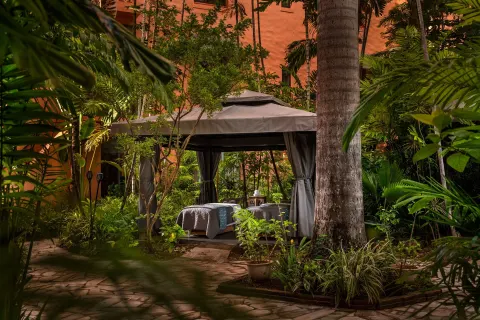 Outdoor spa cabana set in tropical gardens at The Royal Hawaiian, Waikiki.
