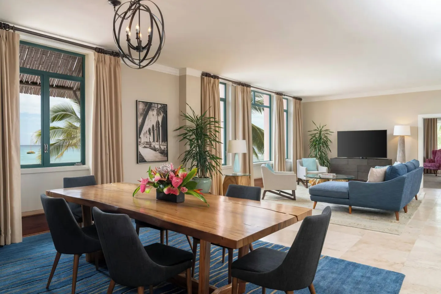 Suite living and dining area with ocean-facing windows at The Royal Hawaiian, Waikiki.