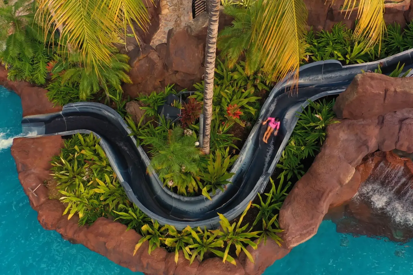 Overhead view of a winding waterslide and pool at The Royal Hawaiian, Waikiki.