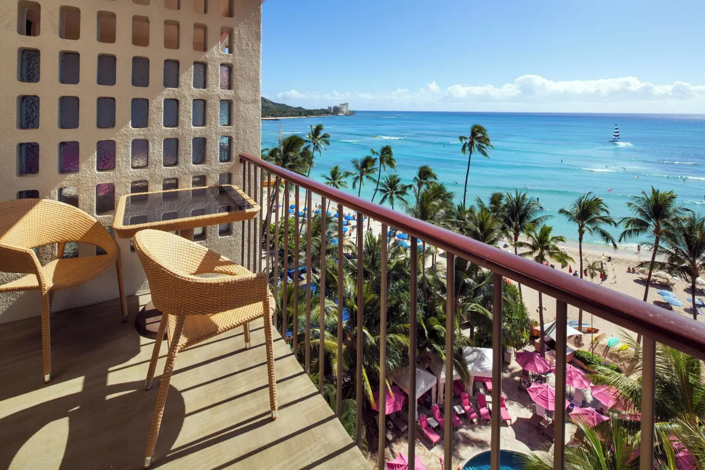 Balcony seating overlooks Waikiki Beach and ocean at The Royal Hawaiian, Waikiki.