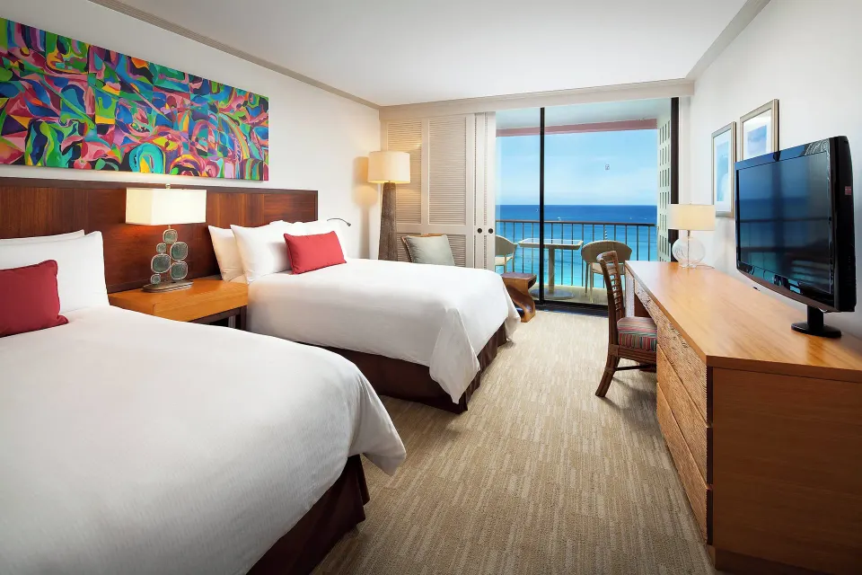 Two-bed oceanfront guest room with balcony at The Royal Hawaiian, Waikiki.