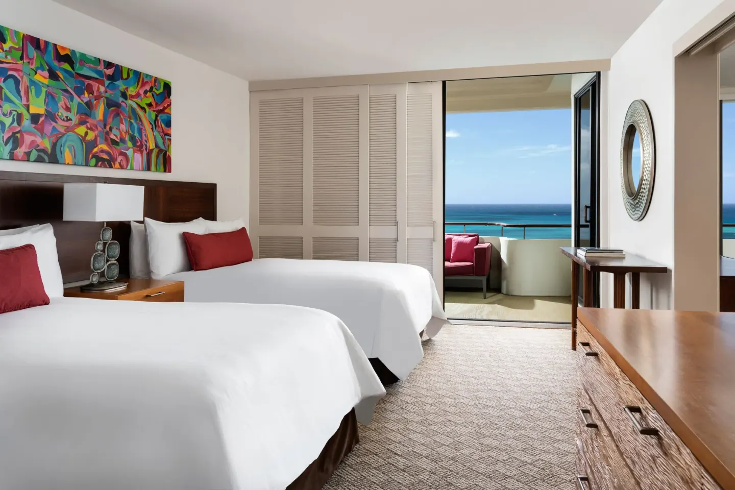 Two beds in an oceanfront bedroom with balcony at The Royal Hawaiian, Waikiki.