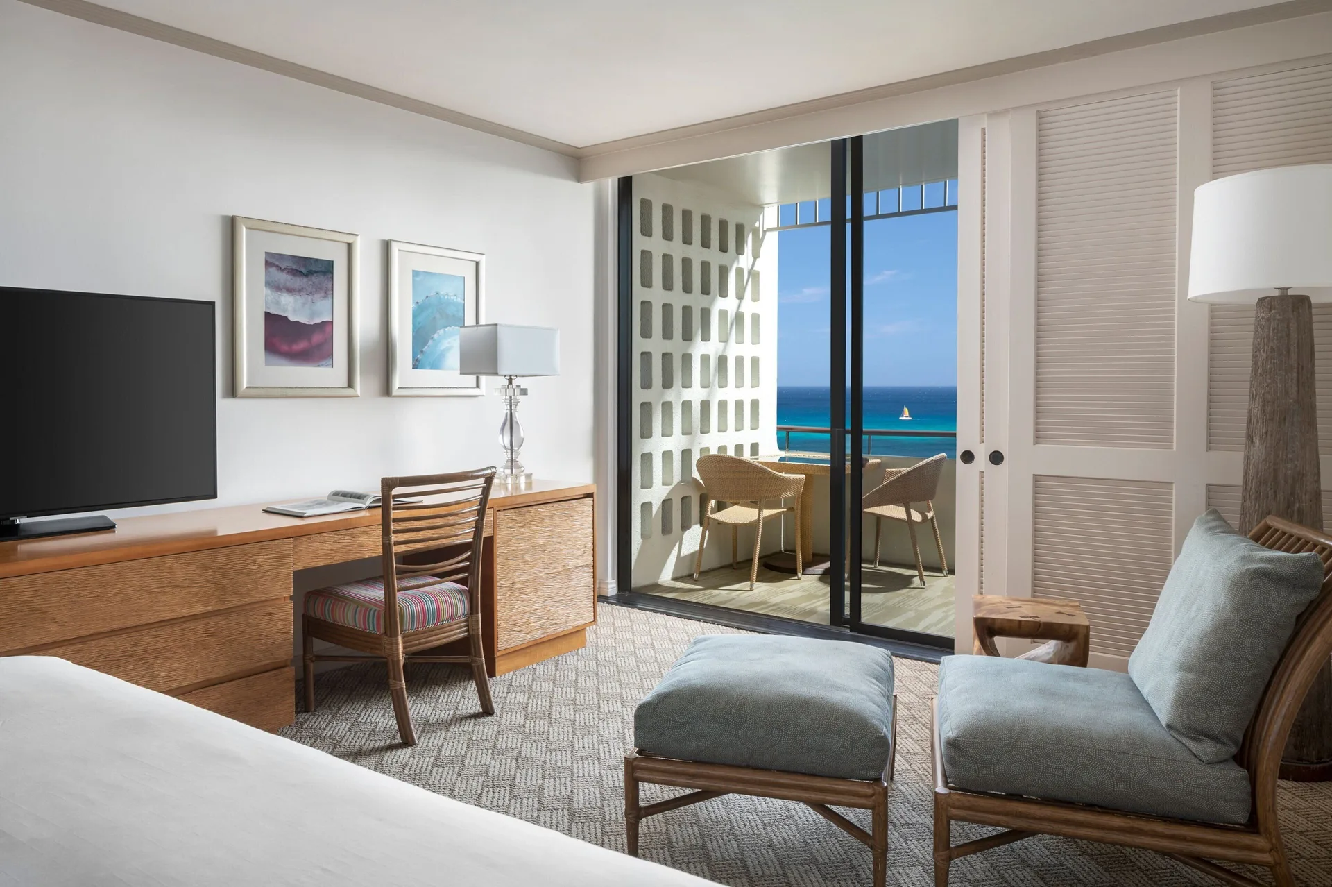 Mailani Tower guest room with ocean-facing balcony seating at The Royal Hawaiian, Waikiki.