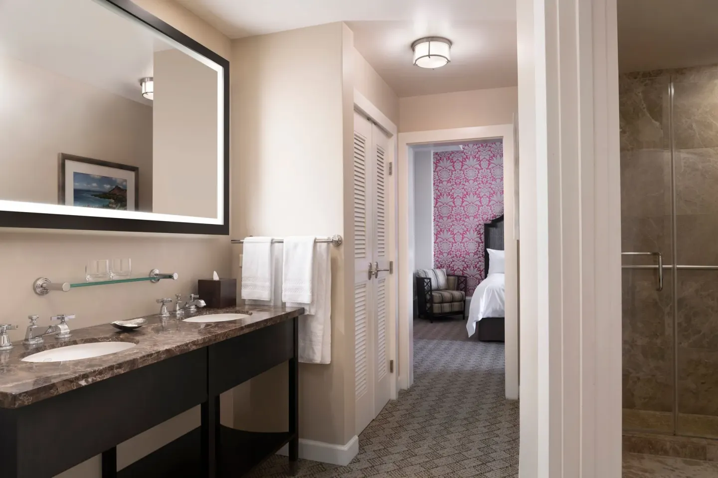 Garden View Historic Wing suite bathroom at The Royal Hawaiian, Waikiki with vanity, towels and shower.