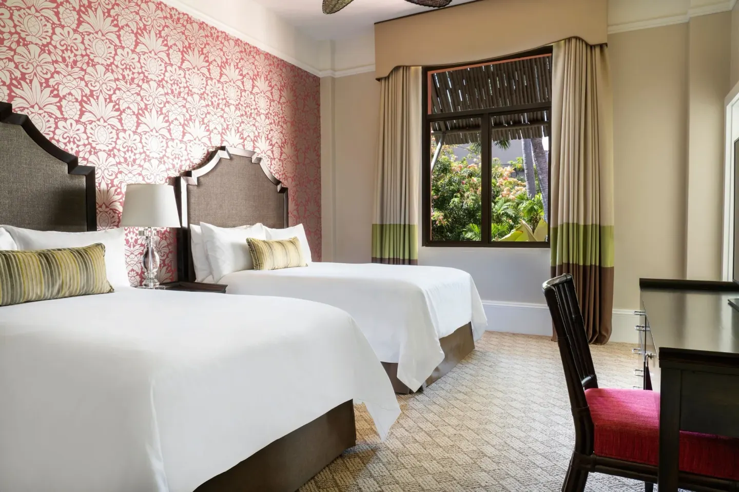 Garden View Historic Wing room with two beds at The Royal Hawaiian, Waikiki beside a window and desk.