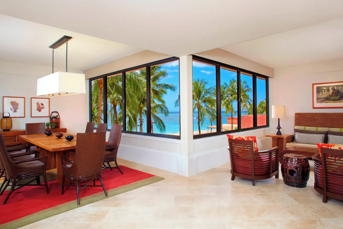 Prestige Suite dining and sitting area with wraparound ocean windows at The Royal Hawaiian, Waikiki.