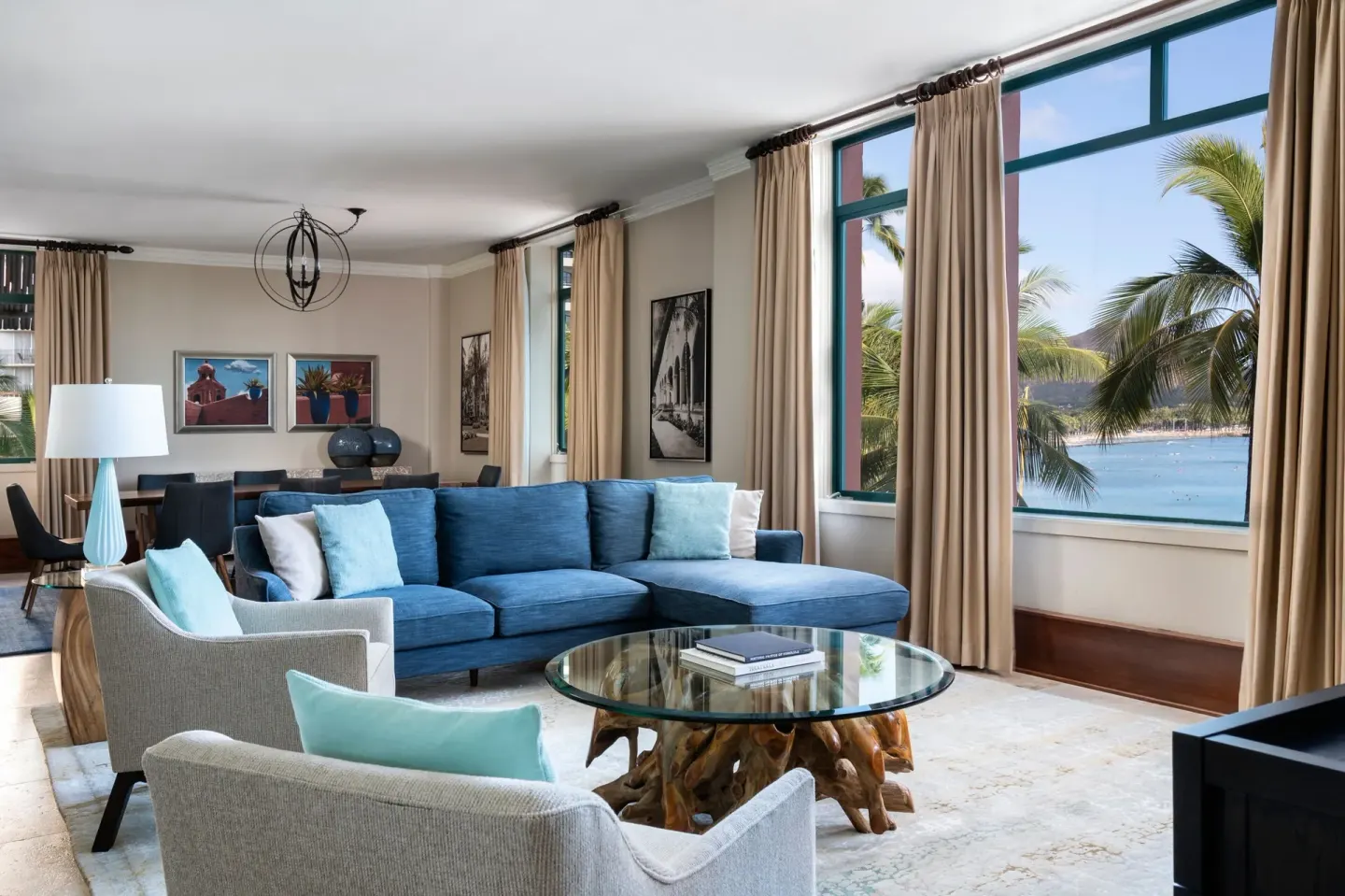 Prestige Suite living room with blue sofa and Waikiki view at The Royal Hawaiian, Waikiki.