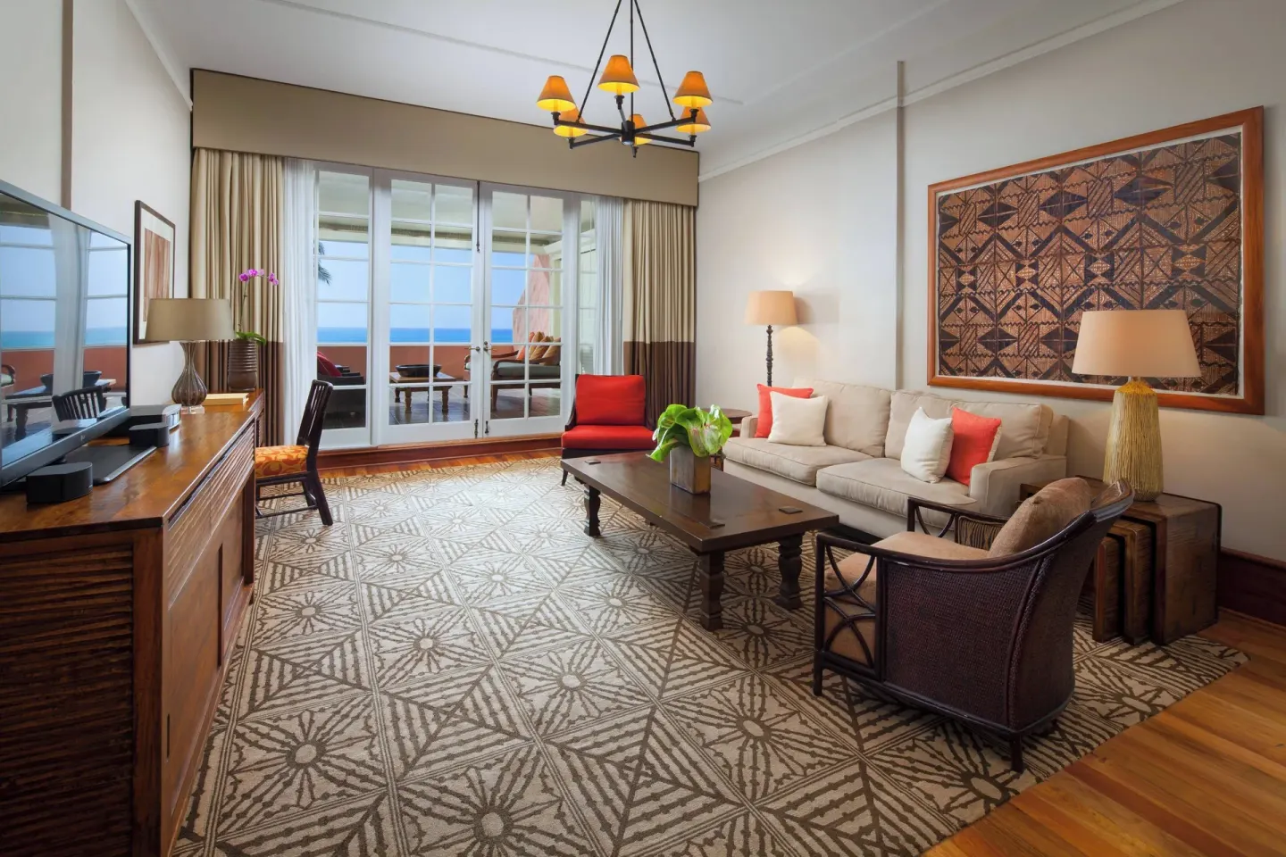Prestige Suite living room with sofa and terrace doors at The Royal Hawaiian, Waikiki.