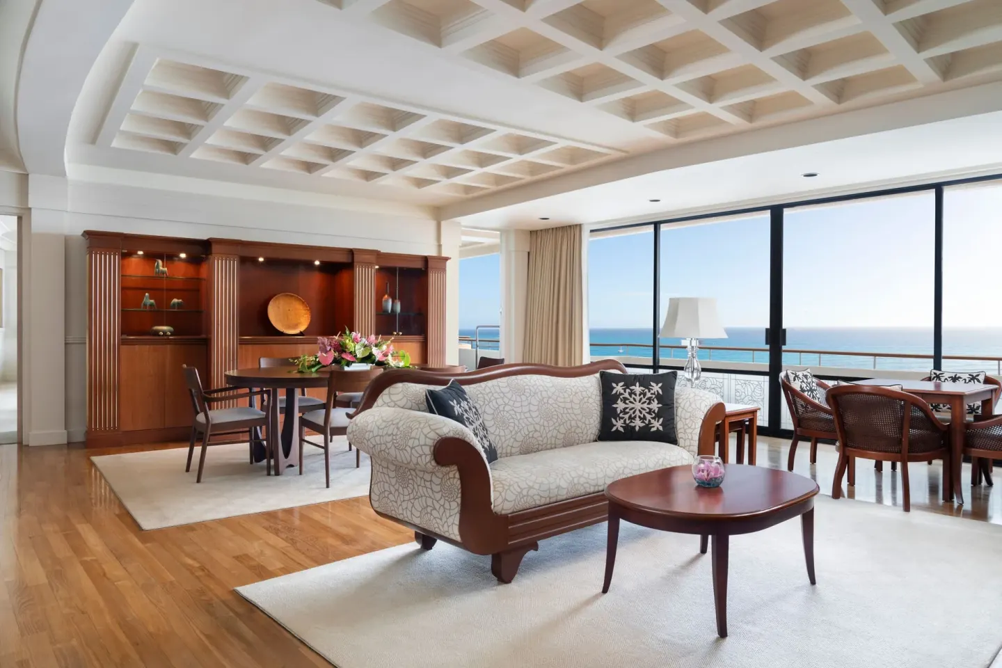 Ocean-view suite living and dining area at The Royal Hawaiian, Waikiki.