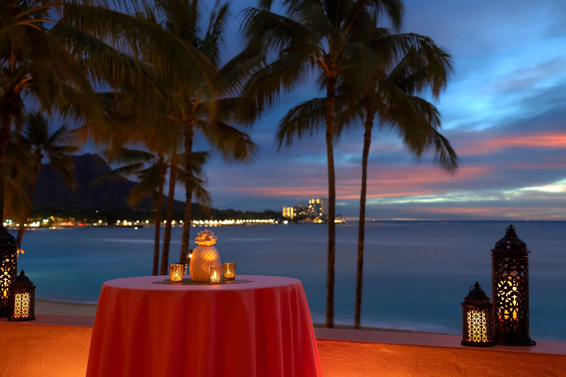 Candlelit cocktail table overlooking Waikiki Beach at The Royal Hawaiian, Waikiki.