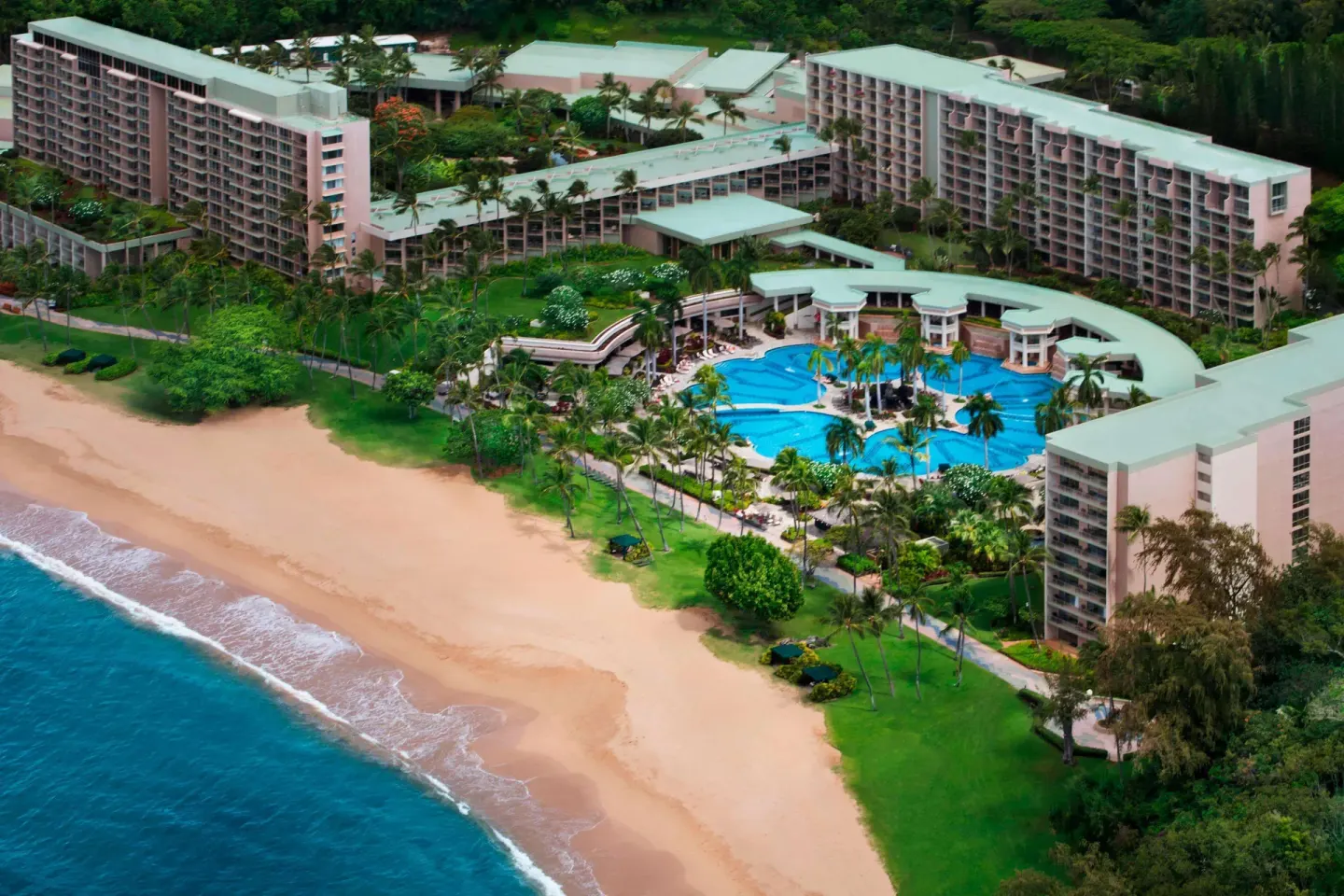 Aerial view of the beachfront resort, pool, and sand at The Royal Sonesta Kaua'i Resort Lihue.