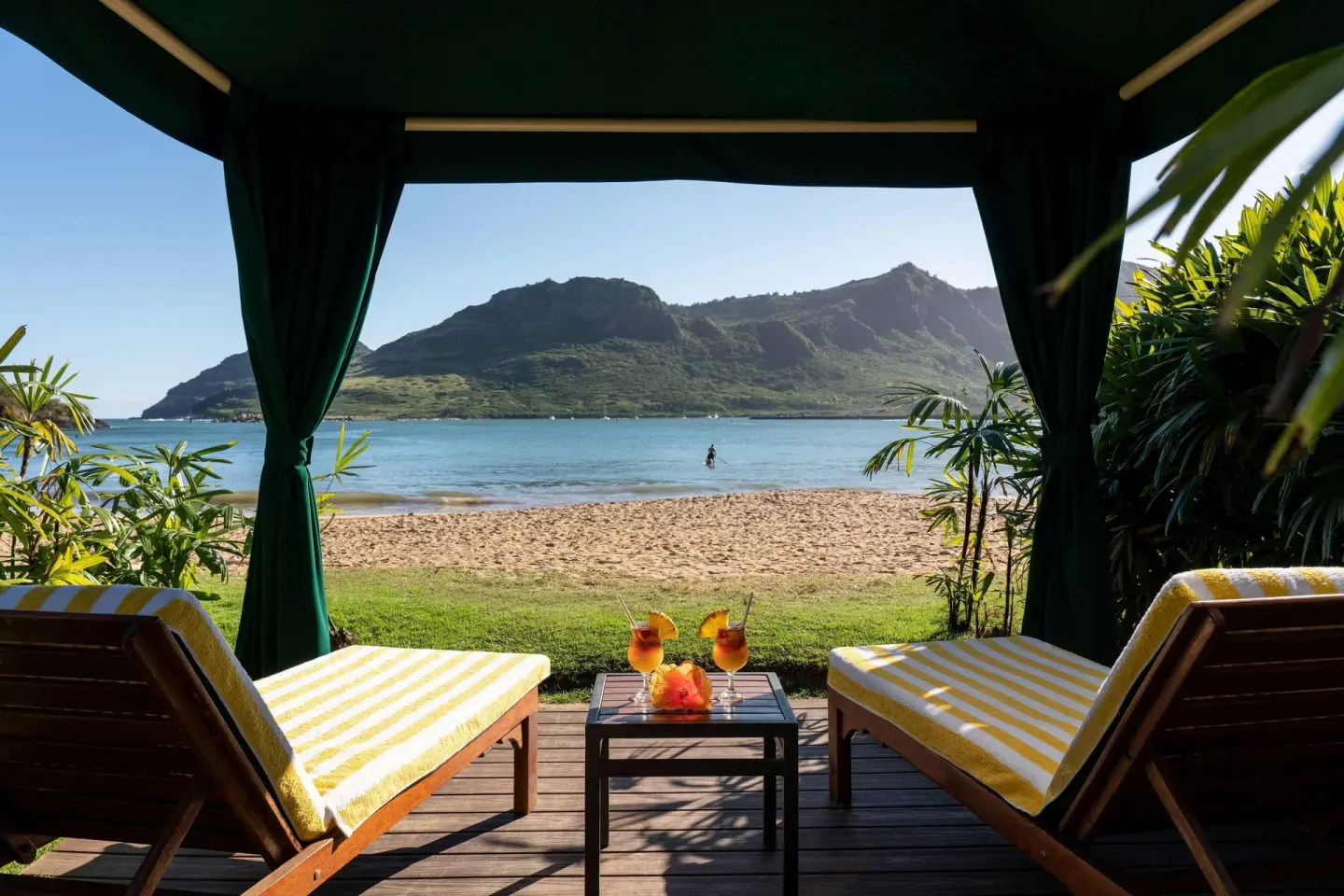 Beach cabana with lounge chairs facing the bay at The Royal Sonesta Kaua'i Resort Lihue.