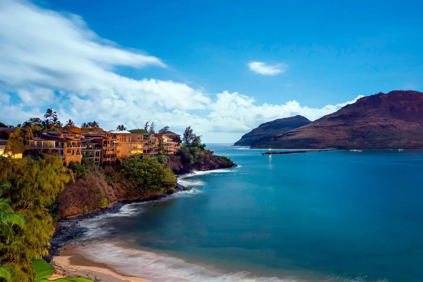 Cliffside resort buildings and blue bay near The Royal Sonesta Kaua'i Resort Lihue.