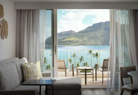 Guest room sitting area with balcony bay view at The Royal Sonesta Kaua'i Resort Lihue.