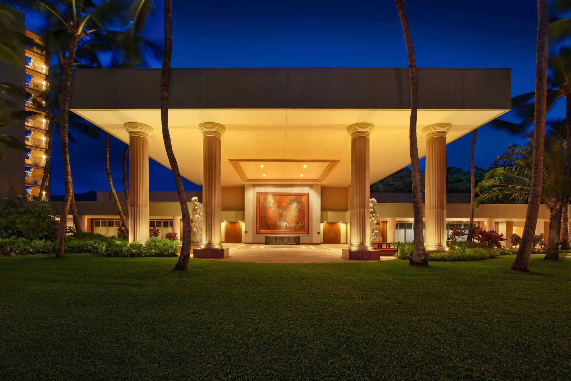 Illuminated resort entrance with columns at The Royal Sonesta Kaua'i Resort Lihue.