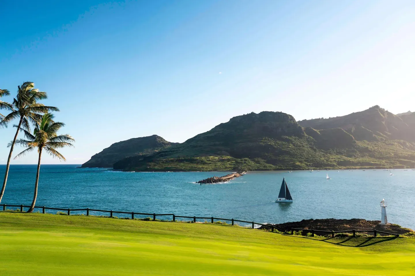 Bay, palms, mountains and sailboats near The Royal Sonesta Kaua'i Resort Lihue.