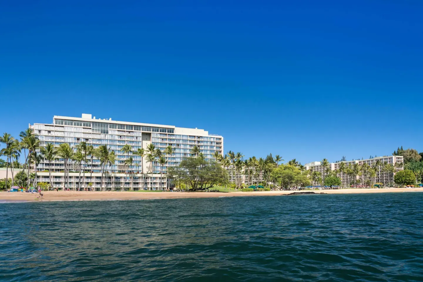 Oceanfront hotel buildings seen from the water at The Royal Sonesta Kaua'i Resort Lihue.