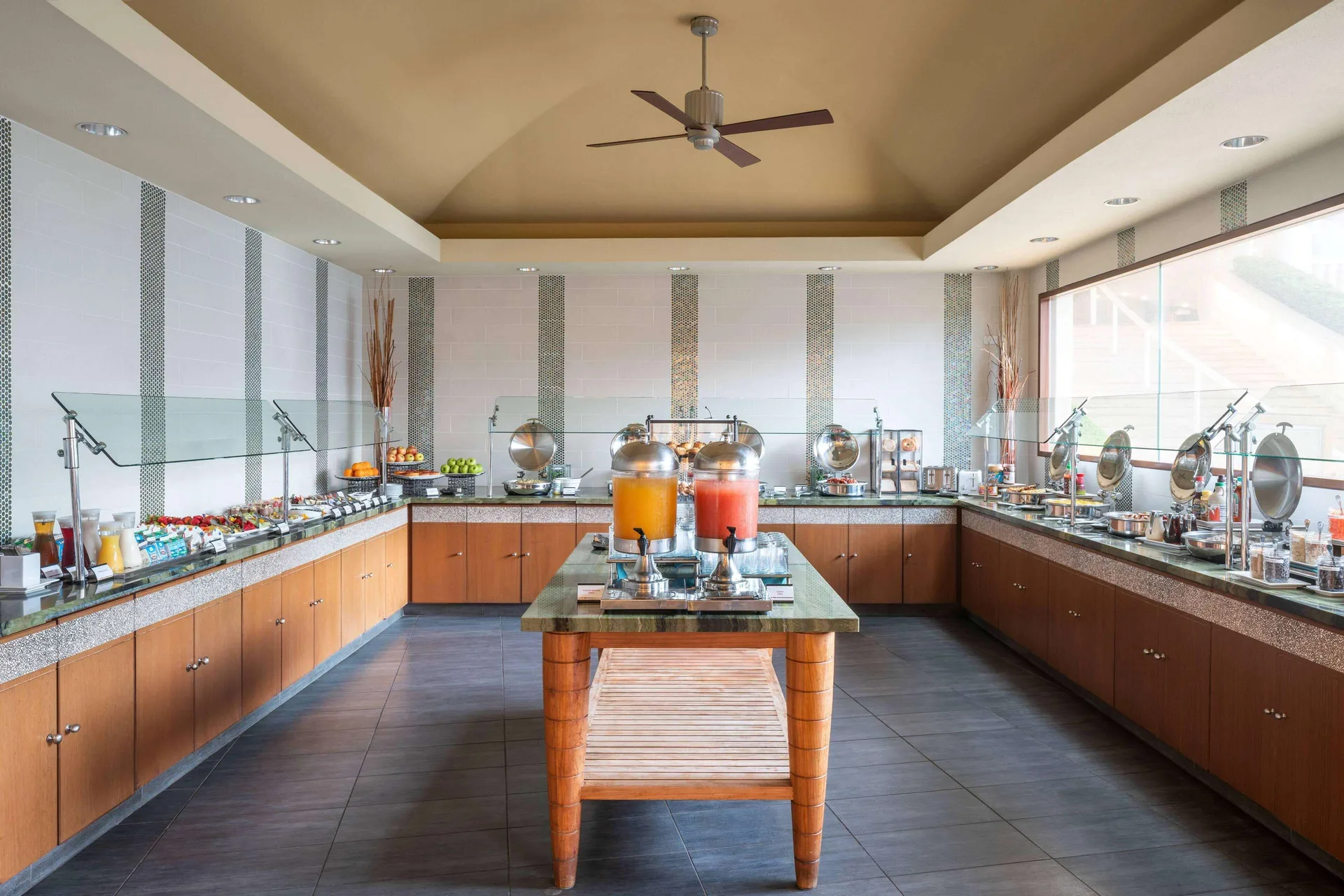 A breakfast buffet with juice dispensers is arranged at The Royal Sonesta Kaua'i Resort Lihue.