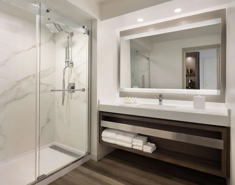 Bathroom with glass shower in a Deluxe Ground Floor Lanai room at The Royal Sonesta Kaua'i Resort Lihue.