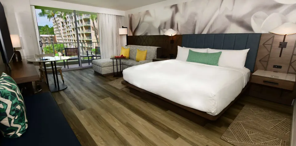 Deluxe Ground Floor Lanai room with king bed and seating at The Royal Sonesta Kaua'i Resort Lihue.