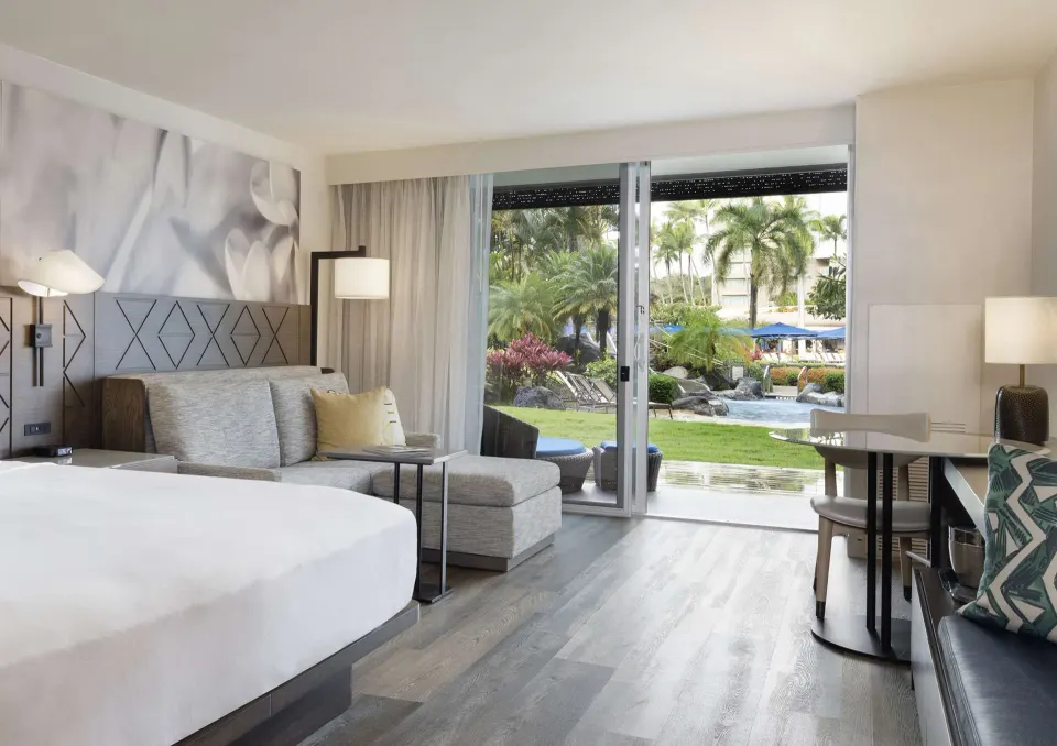 Deluxe Ground Floor Lanai room opening to garden and pool views at The Royal Sonesta Kaua'i Resort Lihue.