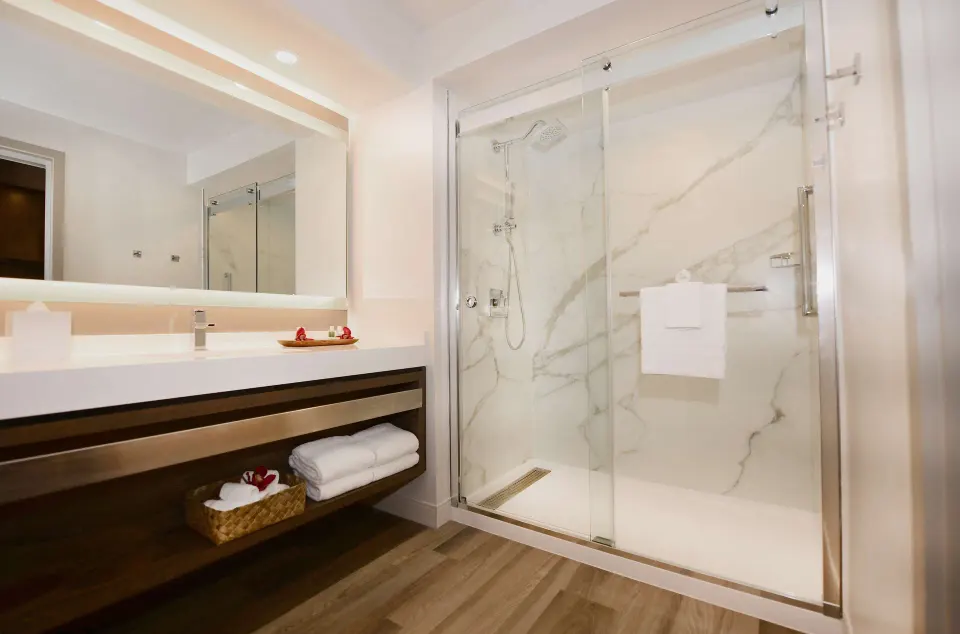 Garden View guest room bathroom with glass shower at The Royal Sonesta Kaua'i Resort Lihue.