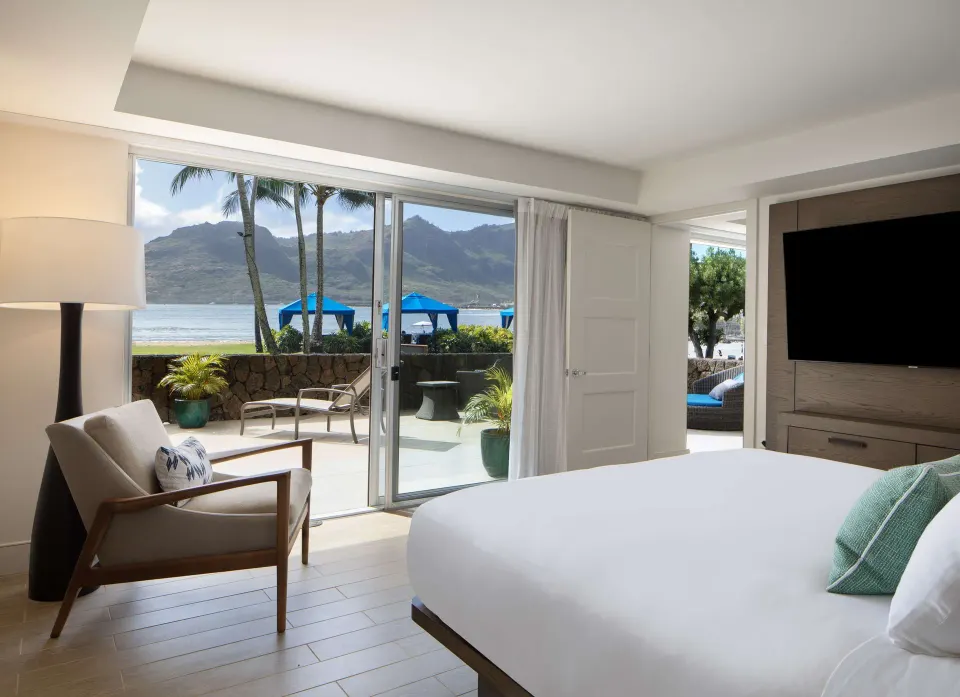 Oceanfront Lanai Suite king bed and patio at The Royal Sonesta Kaua'i Resort Lihue.