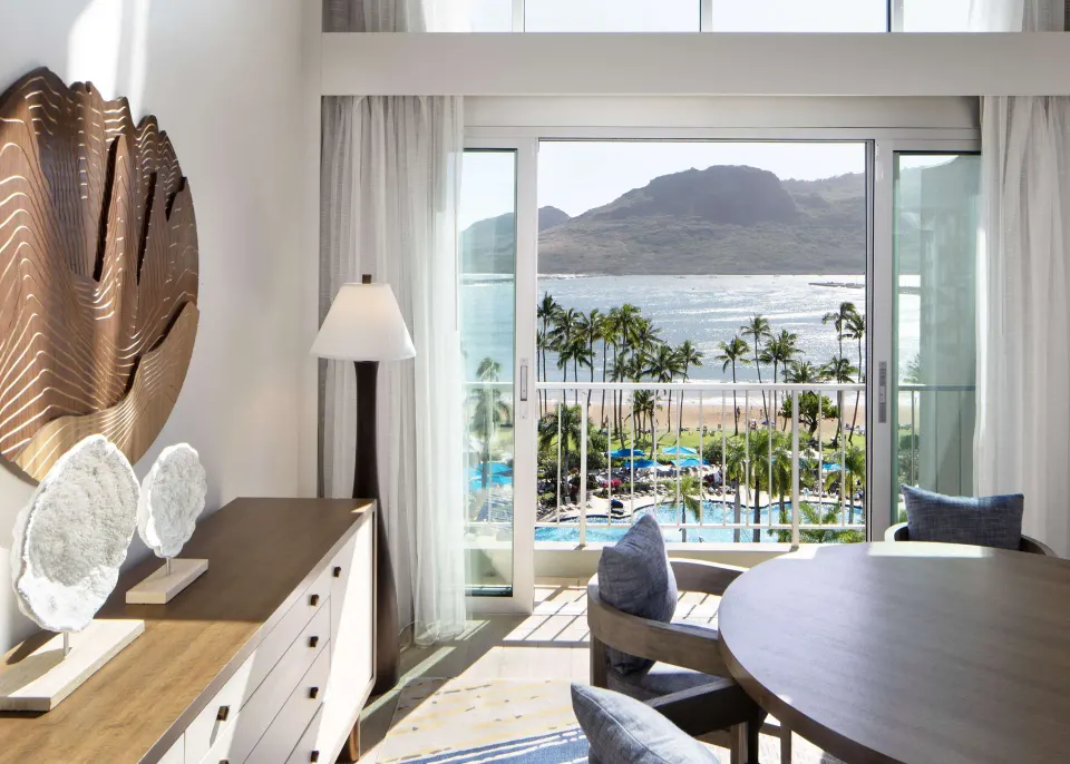 Oceanfront Presidential Suite dining area at The Royal Sonesta Kaua'i Resort Lihue overlooking bay and palms.