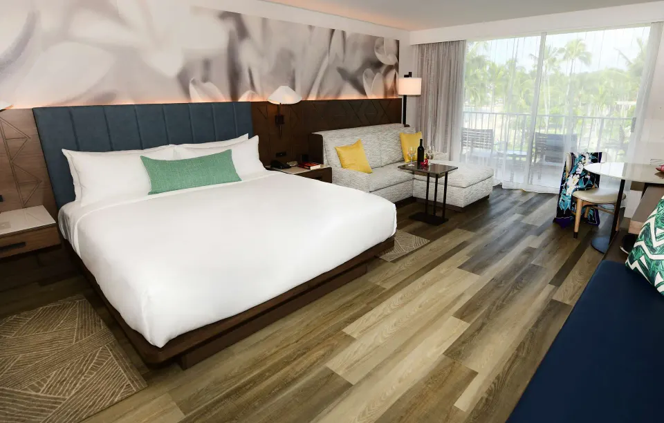 Ocean view guest room with king bed and sitting area at The Royal Sonesta Kaua'i Resort Lihue.